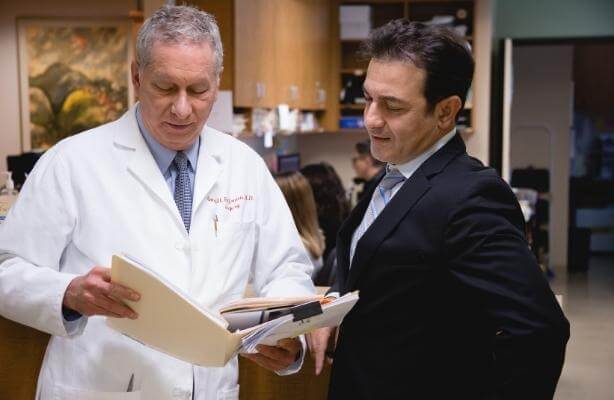 Colon & recal surgeons reviewing a patient's hemorrhoid chart