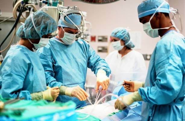 Colorectal doctors doing surgery in an operating room